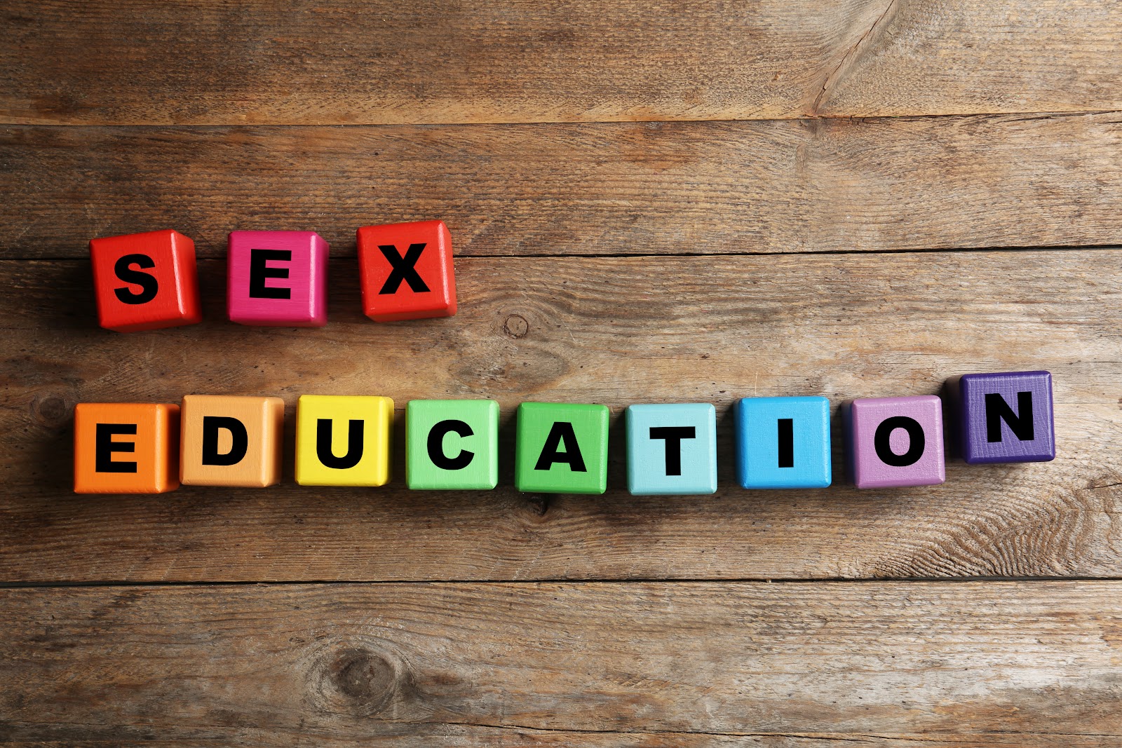 Colorful blocks arranged in a rainbow pattern form the words “Sex Education.” The arrangement rests on a rustic wooden background, creating a vibrant contrast.
Image Credit: Photo 159312687 - “Sex Blocks” © Chernetskaya | Dreamstime.com